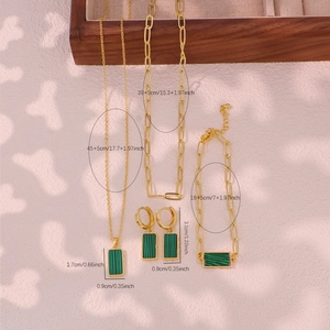Golden jewelry set with green malachite pendants including necklaces earrings and bracelet
