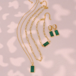 Elegant gold malachite jewelry set featuring layered paperclip necklace bracelet and earrings