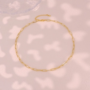Macro shot of gold paperclip chain necklace with lobster clasp and extension links