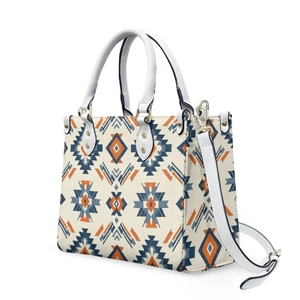 Detail view of Aztec geometric pattern on stylish cream white crossbody handbag