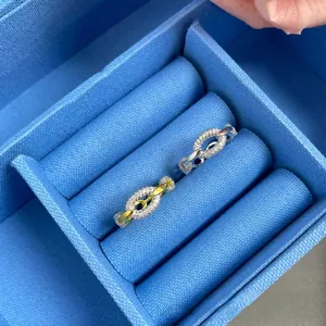 Detailed macro of silver and two-tone chain link rings with inlaid white zircons