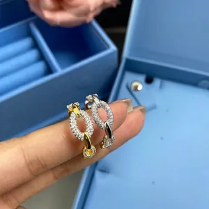 Luxurious chain link hoop earrings with pavé crystals in silver and gold tone finishes