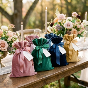 Detail of luxury velvet gift pouches in Morandi colors with wide satin ribbon bows