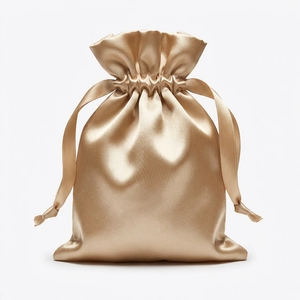 Detailed view of the champagne gold satin drawstring bag with elegant silk-like texture