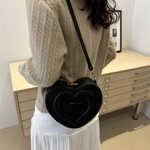 Chic black heart-shaped crossbody bag with gold fashion lettering and thin strap