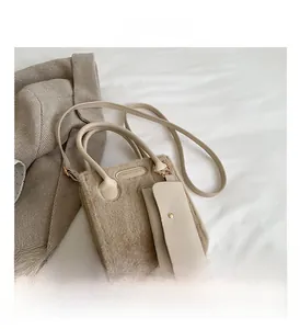 Detail of beige faux fur shoulder bag with leather handle and matching coin purse