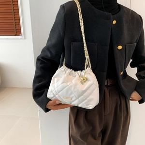 Chic white quilted crossbody bag with gold chain strap and drawstring cloud design