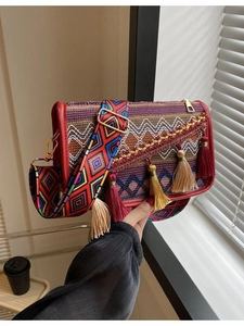 Ethnic style crossbody bag with colorful woven geometric patterns and wide shoulder strap