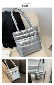 Detail of silver quilted tote bag showing padded texture and spacious front pocket