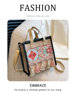 Detailed embroidery and colorful tassels on an ethnic style linen tote bag for women