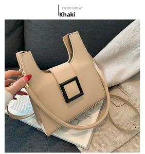 Detail view of khaki PU leather handbag with litchi texture and stylish U-shaped design