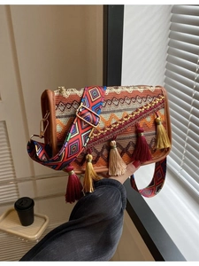 Bohemian knit shoulder bag with colorful fringe and wide ethnic geometric strap