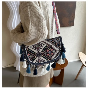 Detailed embroidery and hanging tassels on a bohemian style crossbody bag for women