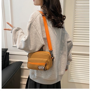 Japanese style canvas crossbody bag in mustard yellow with adjustable orange strap