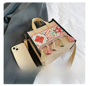 Ethnic embroidery tote bag size comparison with a smartphone showing large capacity