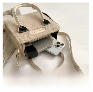Detail view of plush crossbody bag interior showing phone, notepad and cosmetics storage