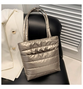 Detail of champagne gold quilted tote bag showing metallic texture and stitching