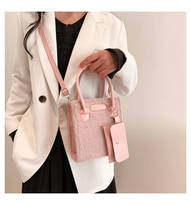 Pink plush handbag featuring luxury faux fur texture and a matching small charm coin pouch