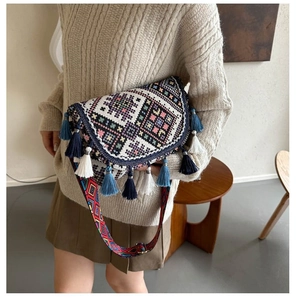 Close-up of ethnic woven crossbody bag with geometric patterns and fringe tassels