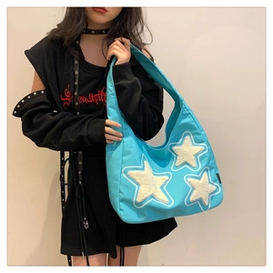 Bright blue nylon tote bag with plush white star patches and large capacity design