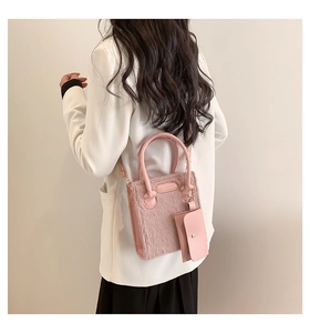 Pink faux fur tote bag detail with leather handles and matching small pouch