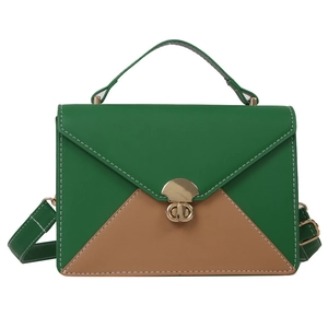 Petit sac bicolore vert et caramel avec fermoir doré sur fond blanc pur et épuré