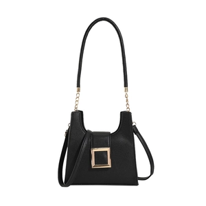 Women's black pebbled leather crossbody bag with golden buckle and chain strap on white background