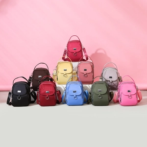 Mini nylon crossbody phone bags in multiple colors with top handle and adjustable straps