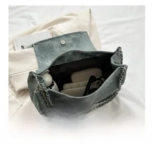 Interior view showing the large capacity of the denim tote bag with daily essentials
