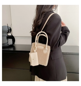Detail showing plush beige faux fur tote with leather handle and matching envelope pouch