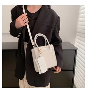 Close-up of cream faux fur crossbody bag with mini pouch and gold hardware details
