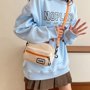 Japanese style beige canvas crossbody bag with bright orange strap and niru logo