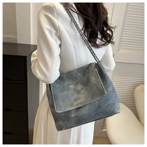 Side view of a vintage grey chain shoulder bag showing its large capacity and soft texture