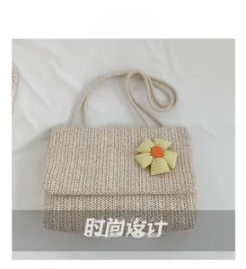 Close-up of beige woven tote bag with sunflower decoration and cotton rope strap