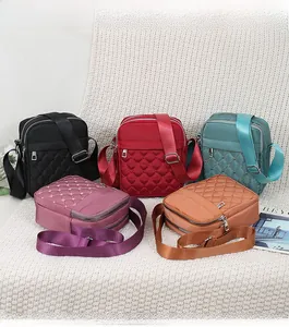 Multiple colors of quilted nylon crossbody bags with zip pockets and adjustable straps
