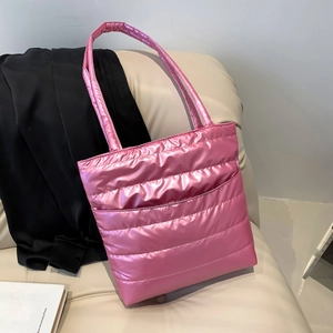 Quilted metallic pink puffer handbag with stylish padded design and wide shoulder strap