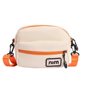 Minimalist cream canvas crossbody bag with vibrant orange zipper and shoulder strap