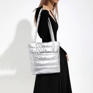 Silver metallic quilted puffer tote bag with long shoulder straps for winter
