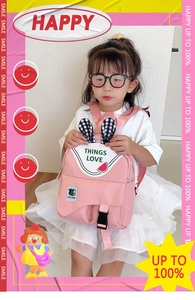 Detail view of pink kids backpack featuring cute rabbit ears and watermelon patch