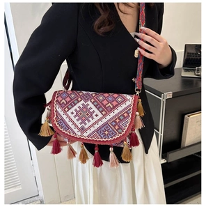 Ethnic style crossbody bag featuring vibrant geometric embroidery and colorful tassels