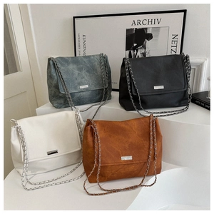 Detail of multi-color chain shoulder bags with vintage texture and metal hardware