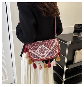 Ethnic embroidered crossbody bag with long colorful tassels and geometric patterns