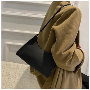 Black matte hobo bag worn on the shoulder showing the actual size and fit on a model