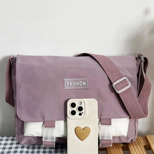 Large canvas messenger bag in purple and white patchwork with adjustable shoulder strap