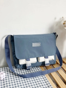 Detail showing the gray-blue canvas tote bag with white front pockets and dual buckles