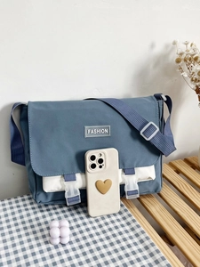 Close-up of stylish blue and white canvas messenger bag with adjustable shoulder strap