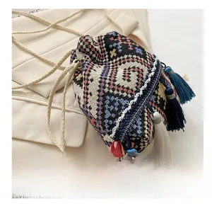 Macro detail of bohemian bucket bag with geometric patterns and long multi-color tassels
