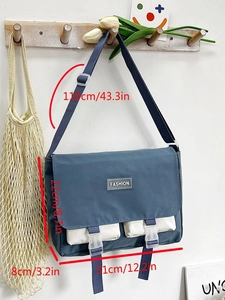 Detailed view of blue canvas tote bag showing dimensions and white contrast pockets
