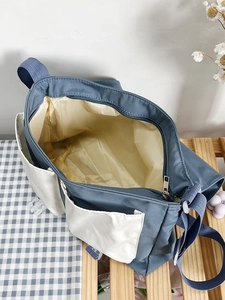 Bird's-eye view of the spacious blue canvas tote bag showing inner lining and metal zipper