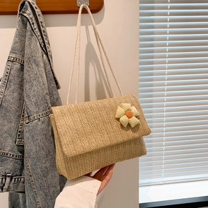 Minimalist straw woven shoulder bag with checkered floral detail and rope straps